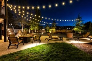 warm string lights and lanterns illuminating an outdoor patio at night