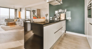 Small apartment kitchen with open shelving, potted herbs and warm pendant lighting