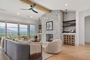 Layered living room lighting with ceiling fan, floor lamp, and accent lights in a modern 2026 home