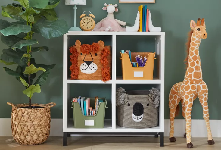 Kids toy storage using cube shelves with labelled fabric bins and a rolling cart