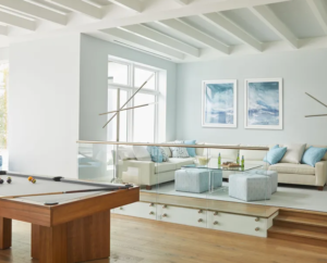 Modern living room with textured accent wall design and framed wall art above a neutral sofa