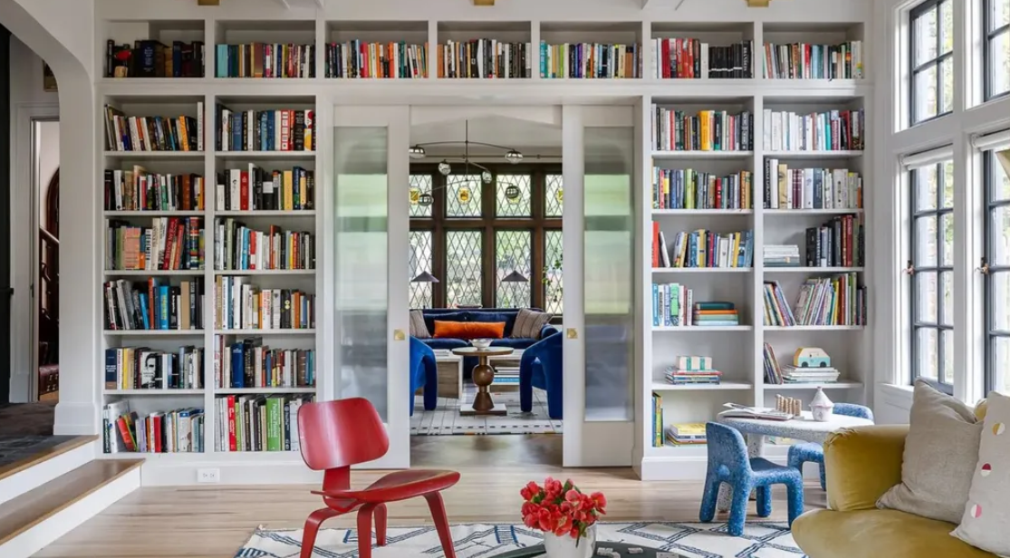 Small living room with clever storage ideas including shelves and an ottoman