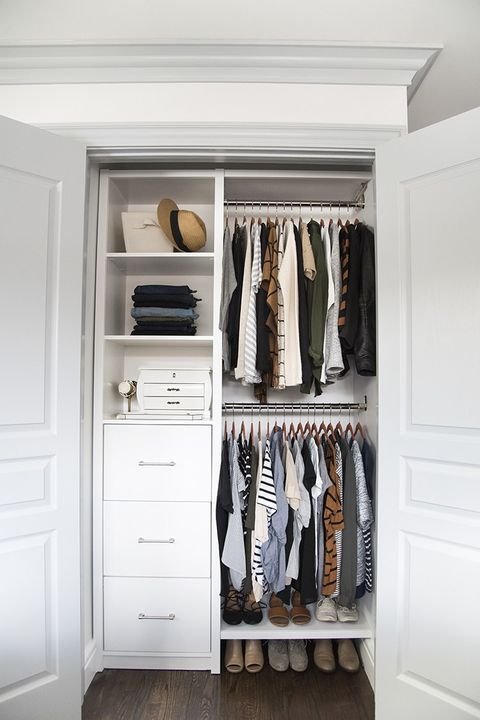 Small closet with double-hang rods and folded clothes on shelf dividers